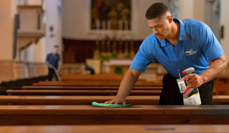 Cleaning crew wiping and vacuuming a place of worship