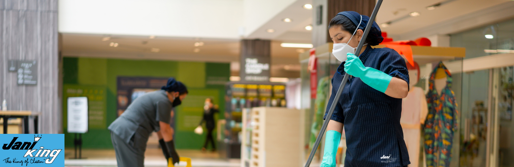 Jani-king employees cleaning a retail store.
