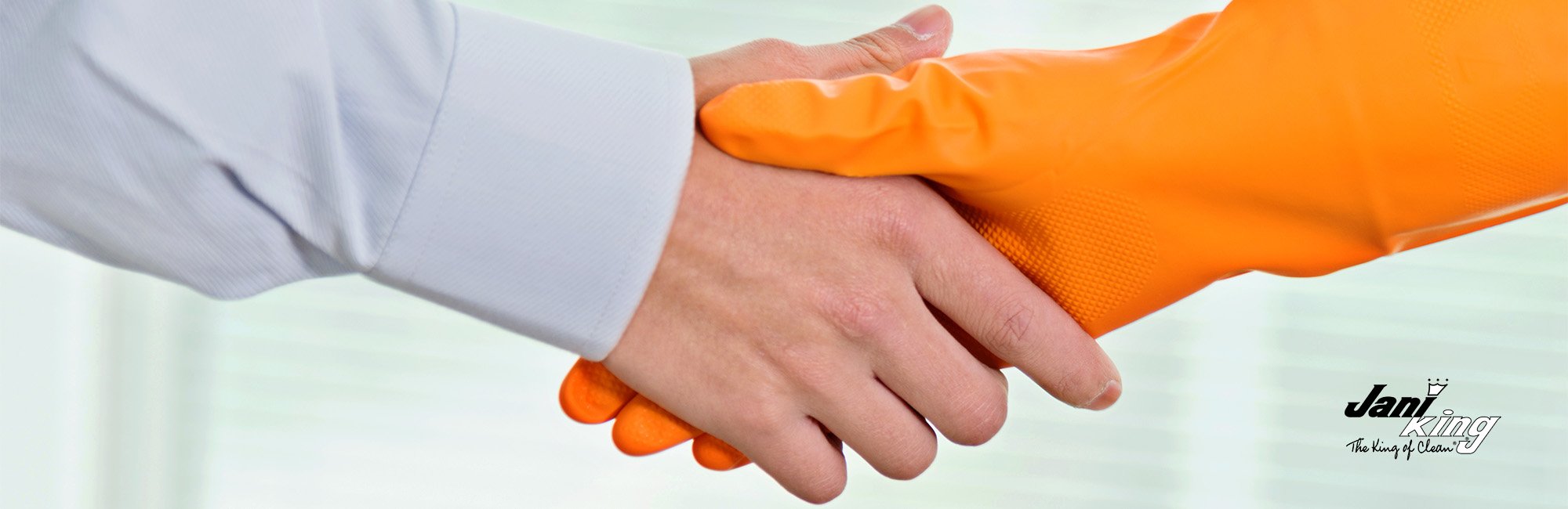 A handshake agreement between a businessman and a commercial cleaner.