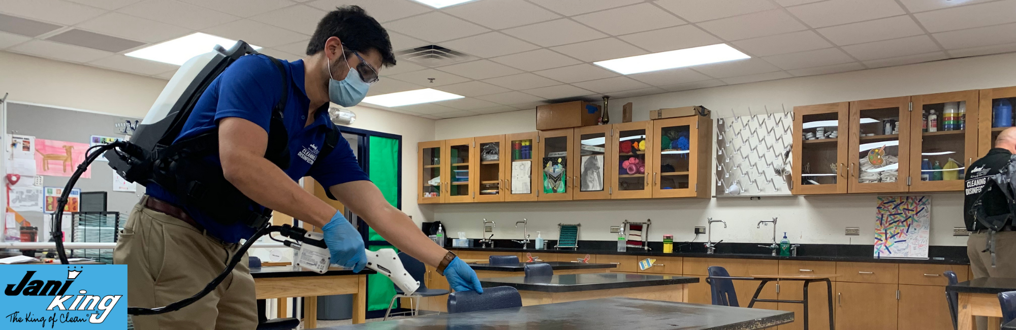 Jani-King employee cleaning a school Science room.