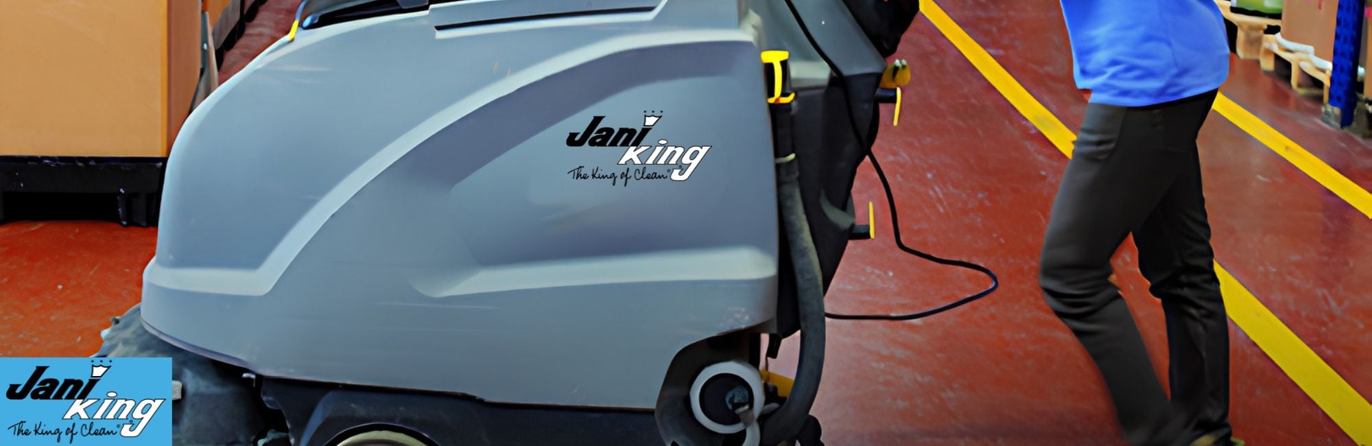 Jani-King employee cleaning an industrial warehouse.