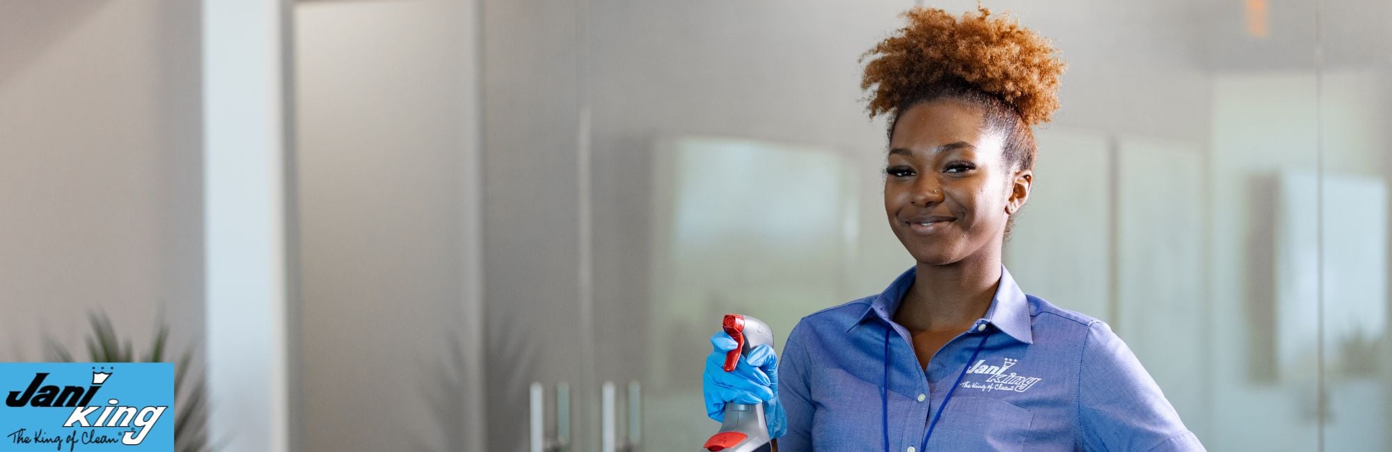 Jani-King employee holding a spray bottle.