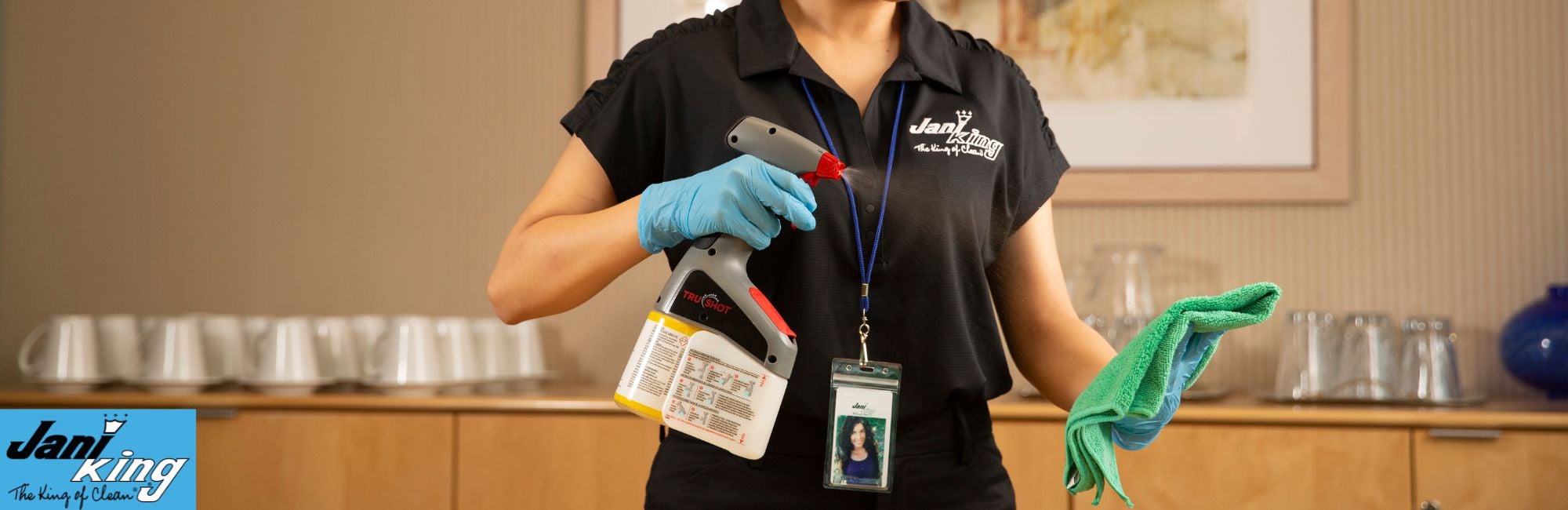 Jani-King employee cleaning office breakroom.