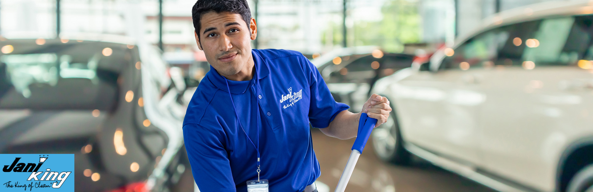 Jani-King employee cleaning an auto dealership.