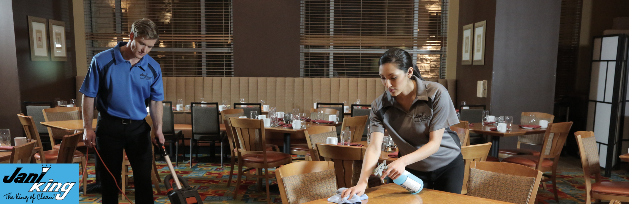 Two Jani-King employees cleaning a restaurant after hours.