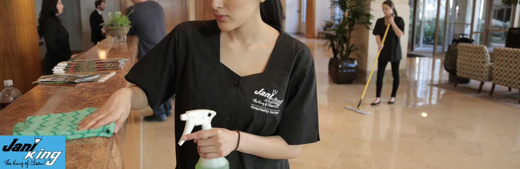 Jani-King employee cleaning the lobby of a hotel.
