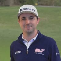 a man in a blue sweater and a white hat